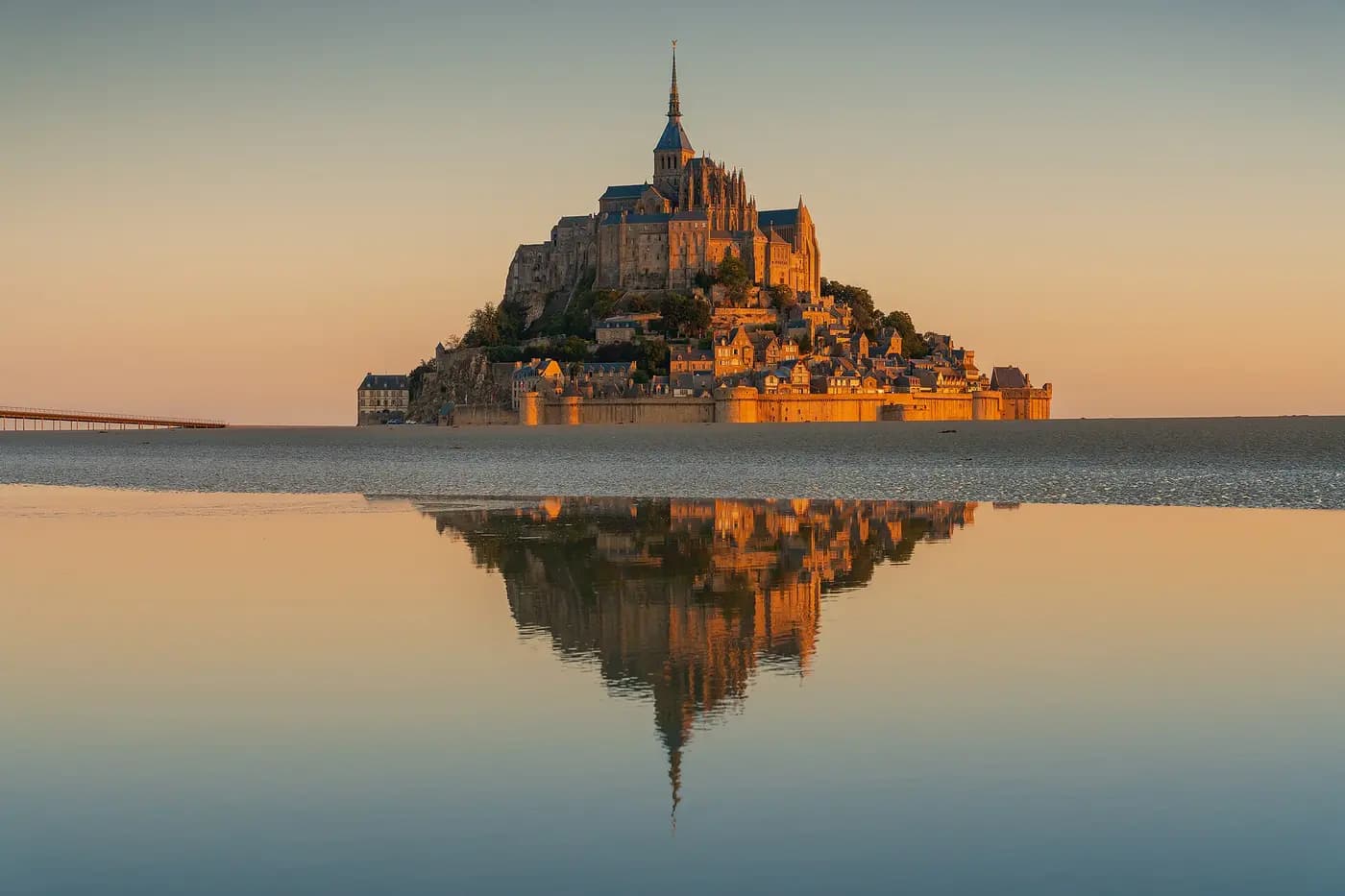 Mont-Saint-Michel abbey rising from the tidal bay at sunrise
