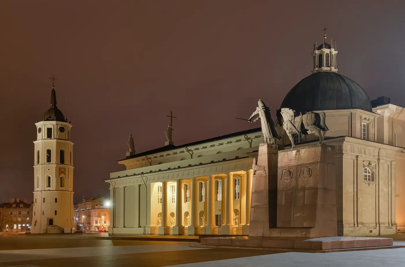 Vilnius Cathedral, its bell tower and the Gediminas statue on Cathedral Square, lit at night