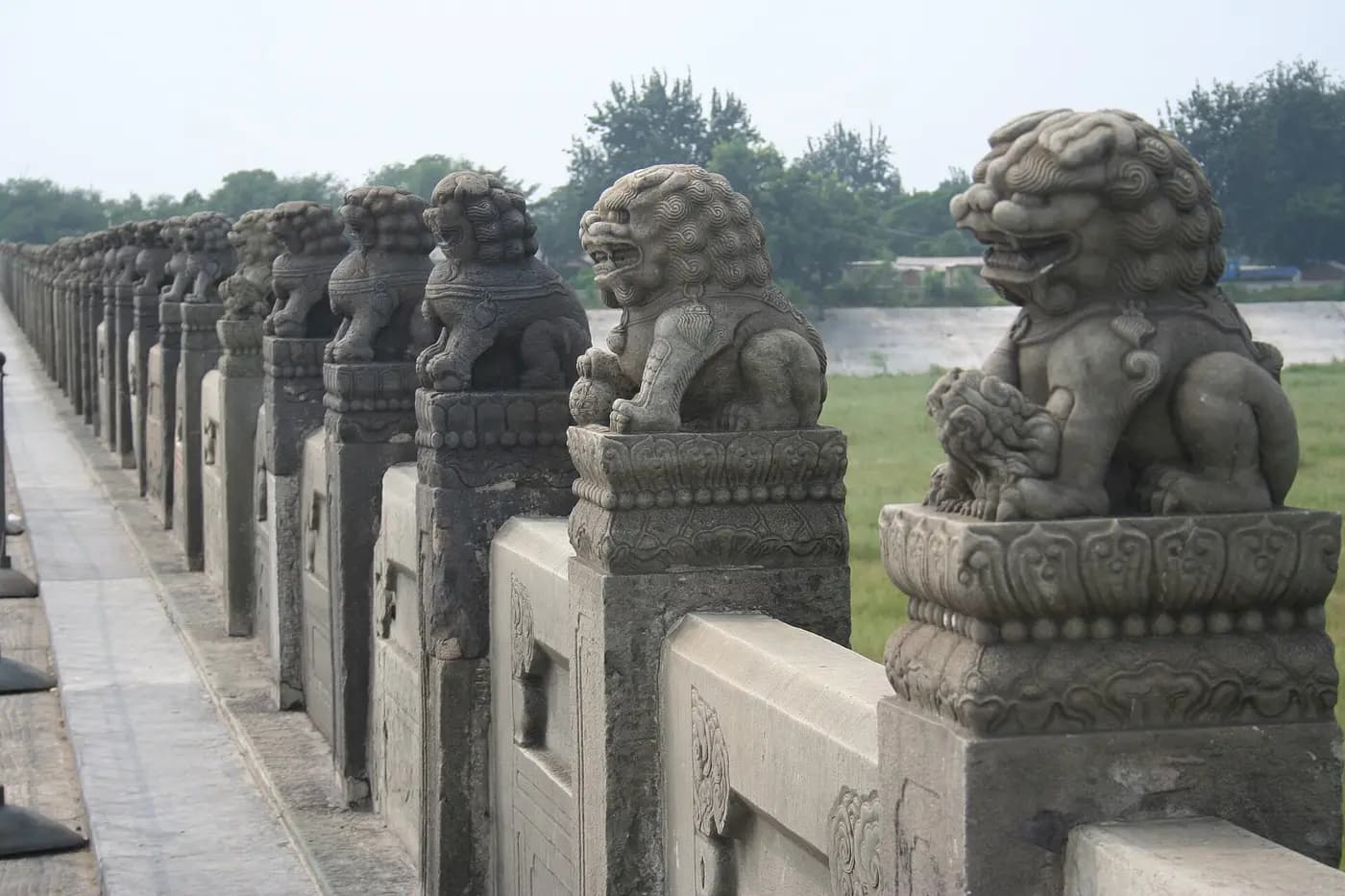 Rows of carved stone lions on the balustrade of the Marco Polo Bridge