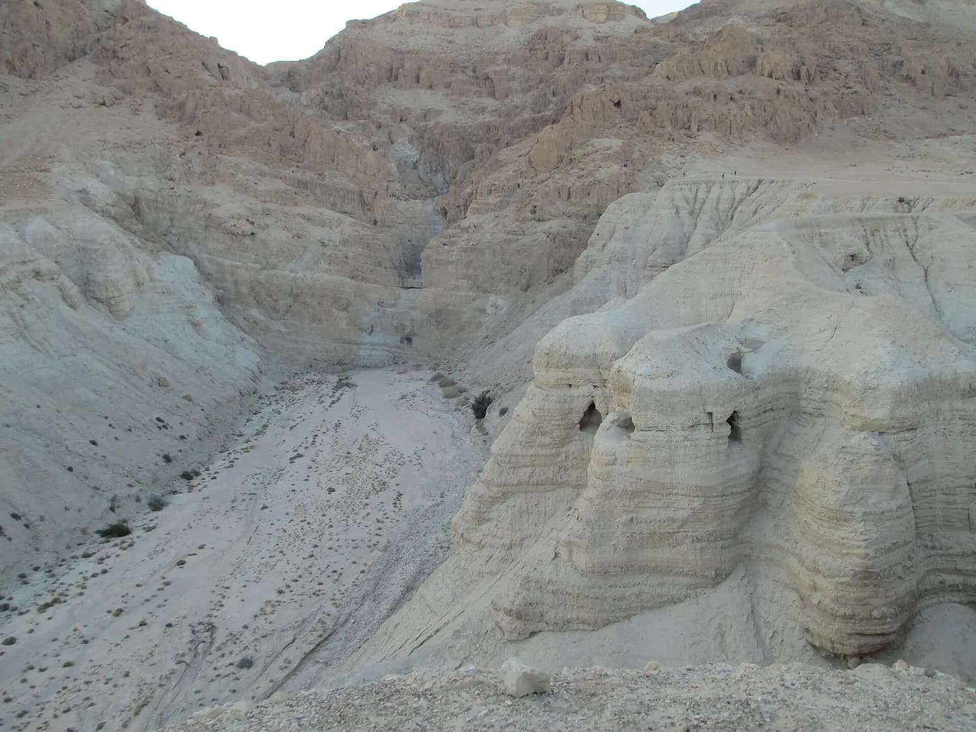 Eroded pale cliffs of Wadi Qumran with the caves where scrolls were found