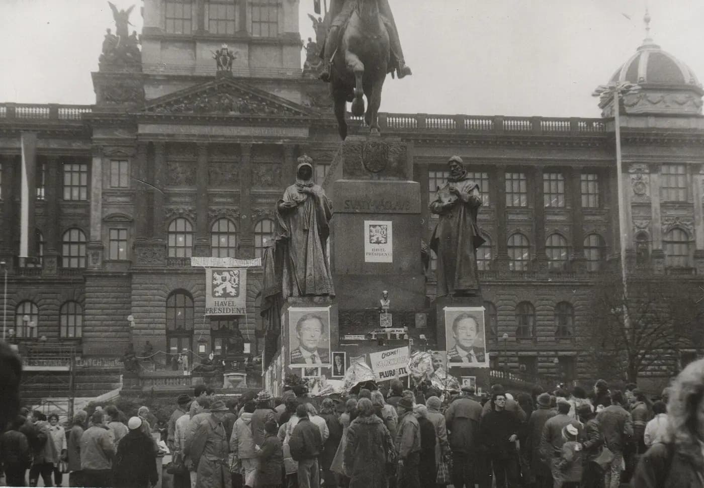 Demonstrators at the St Wenceslas statue in Prague in 1989, beneath posters of Václav Havel