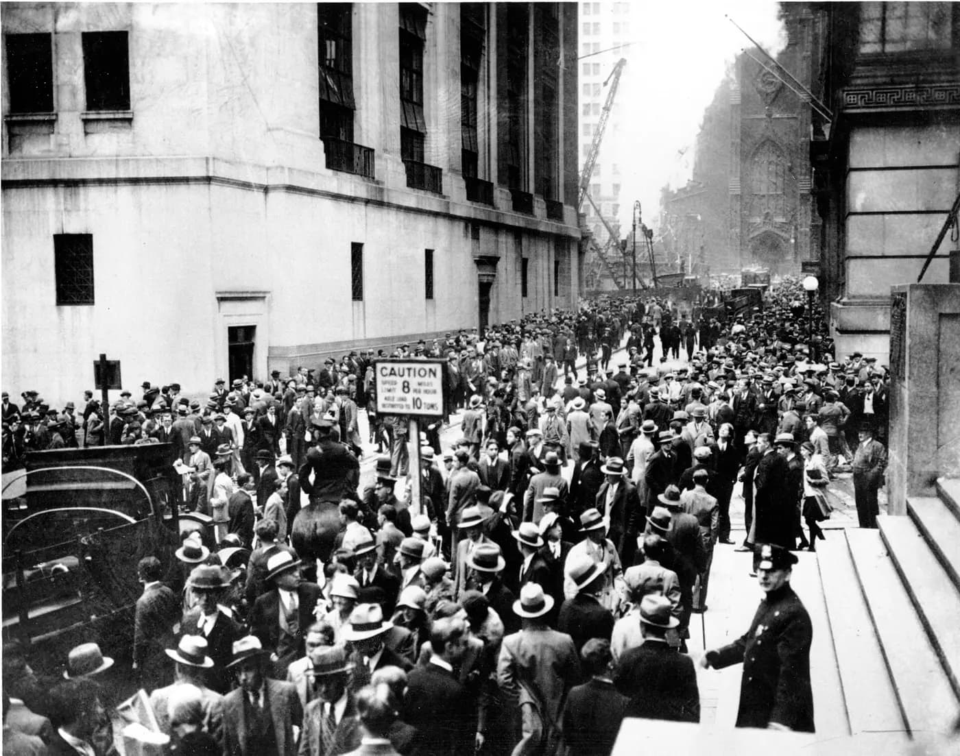Crowds fill Wall Street outside the New York Stock Exchange on 24 October 1929
